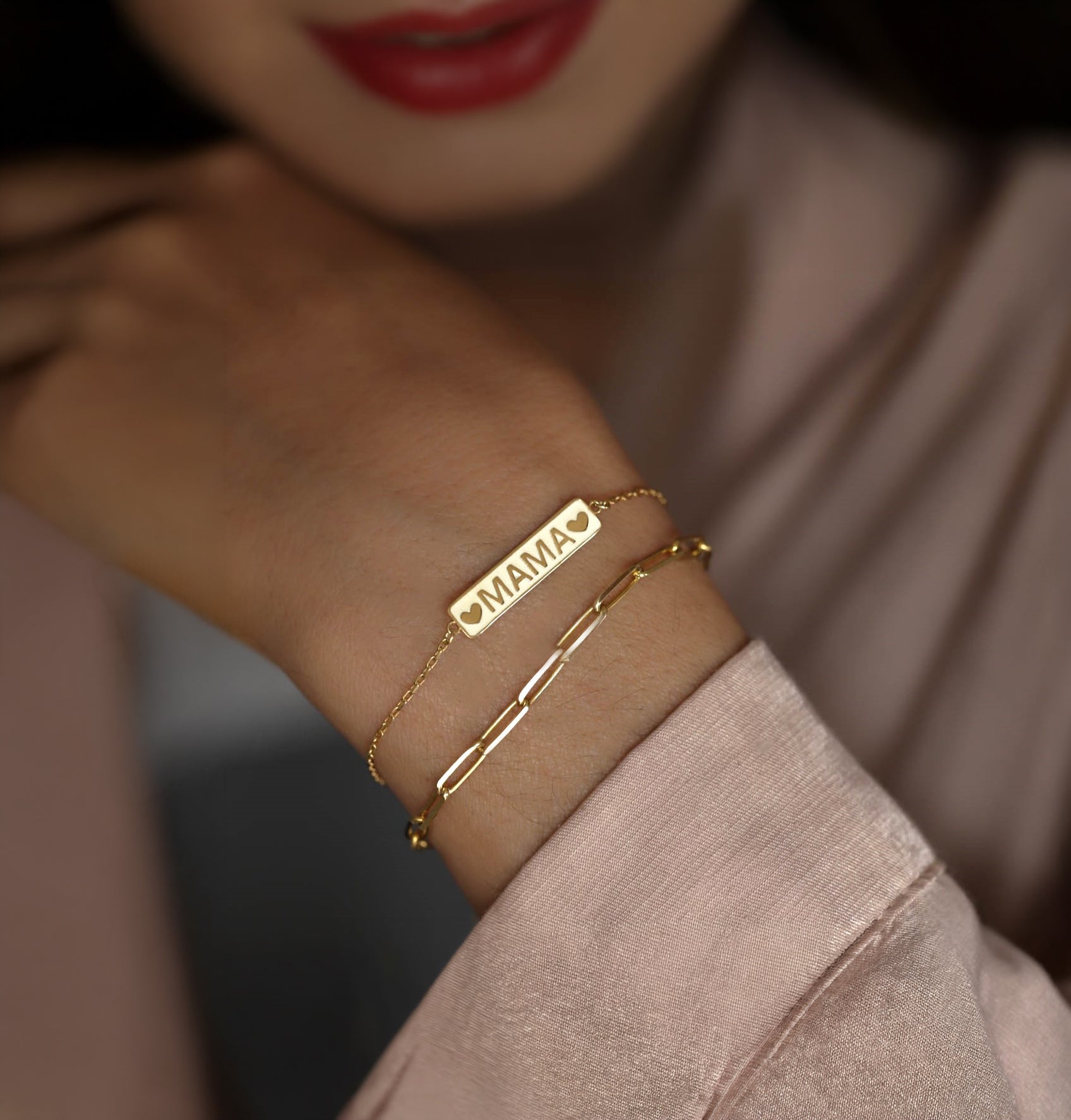 Close up of the trendy 14k gold mama bracelet worn as an everyday luxury statement.