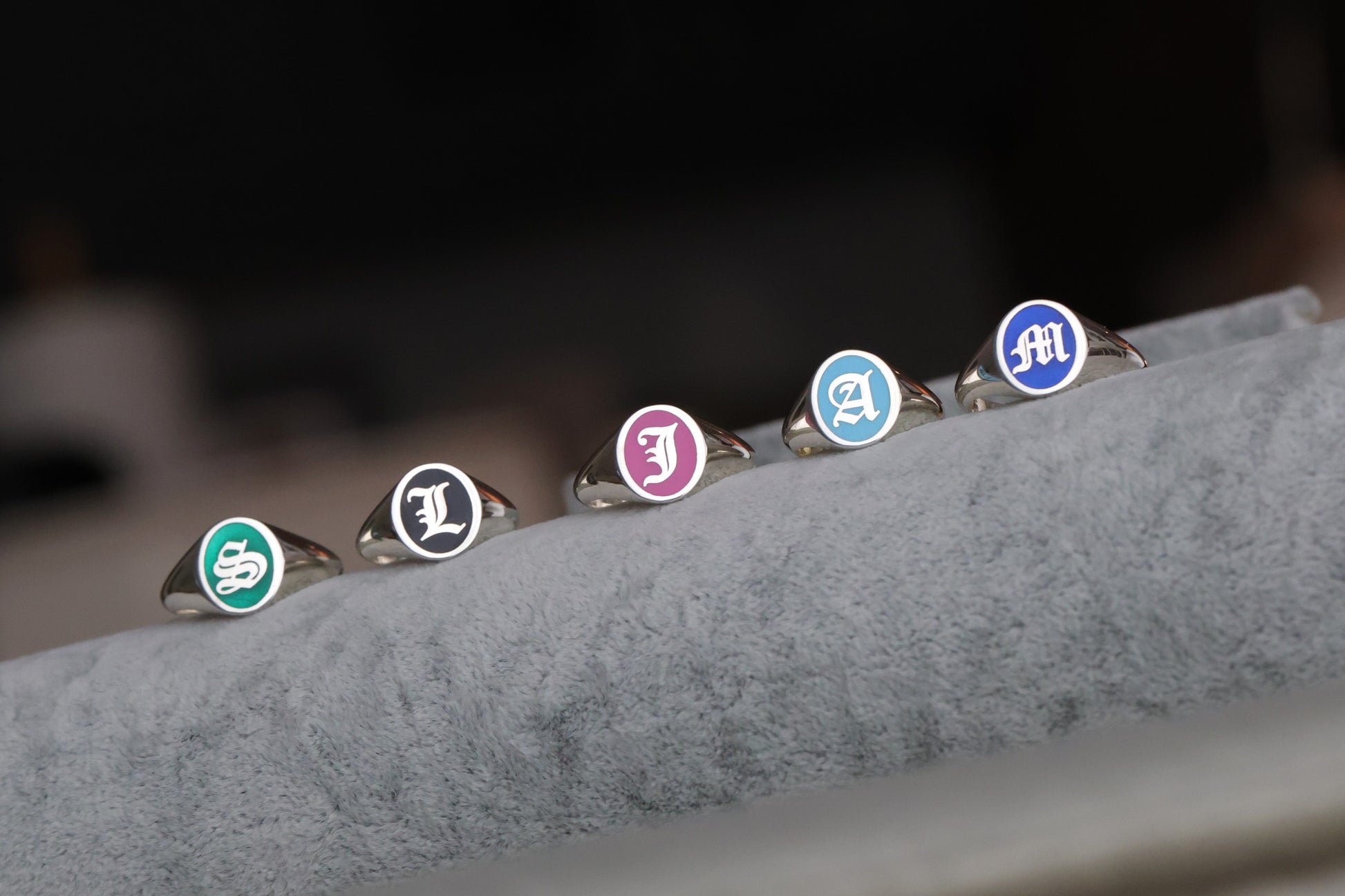 signet rings showing navy blue, baby blue, black, pink and green enamel options.