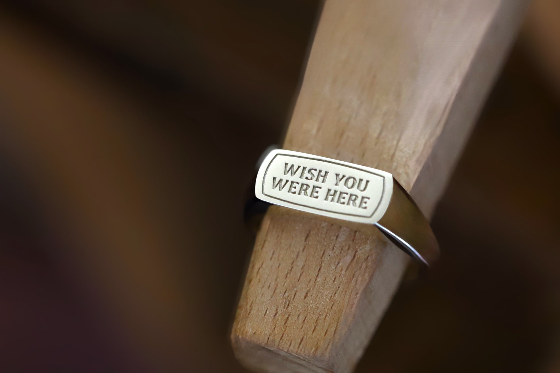 Close up of a deep detailed engraving on a solid gold inspirational quote jewelry ring.