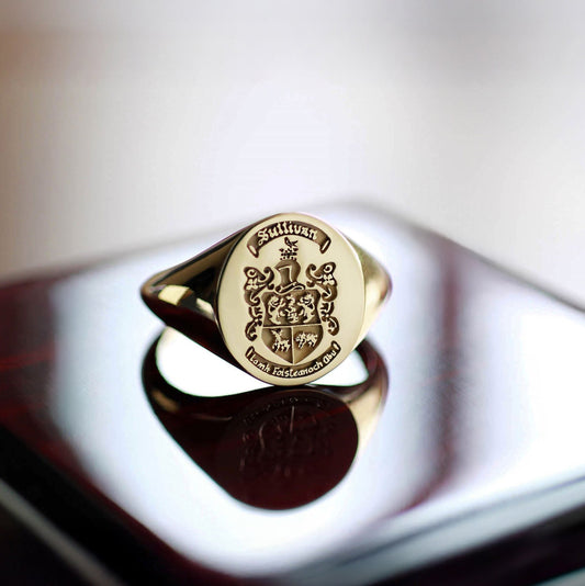Solid gold family crest ring with deep relief engraving for men.
