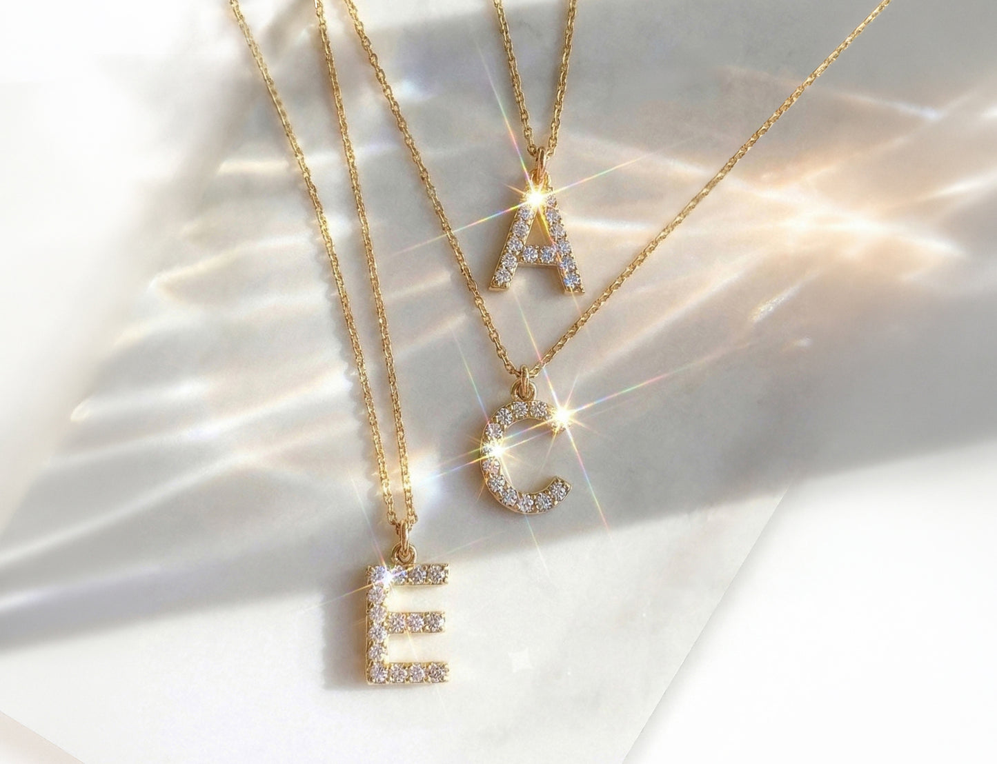 Close up of real diamond letter pendants shining in the sunlight.