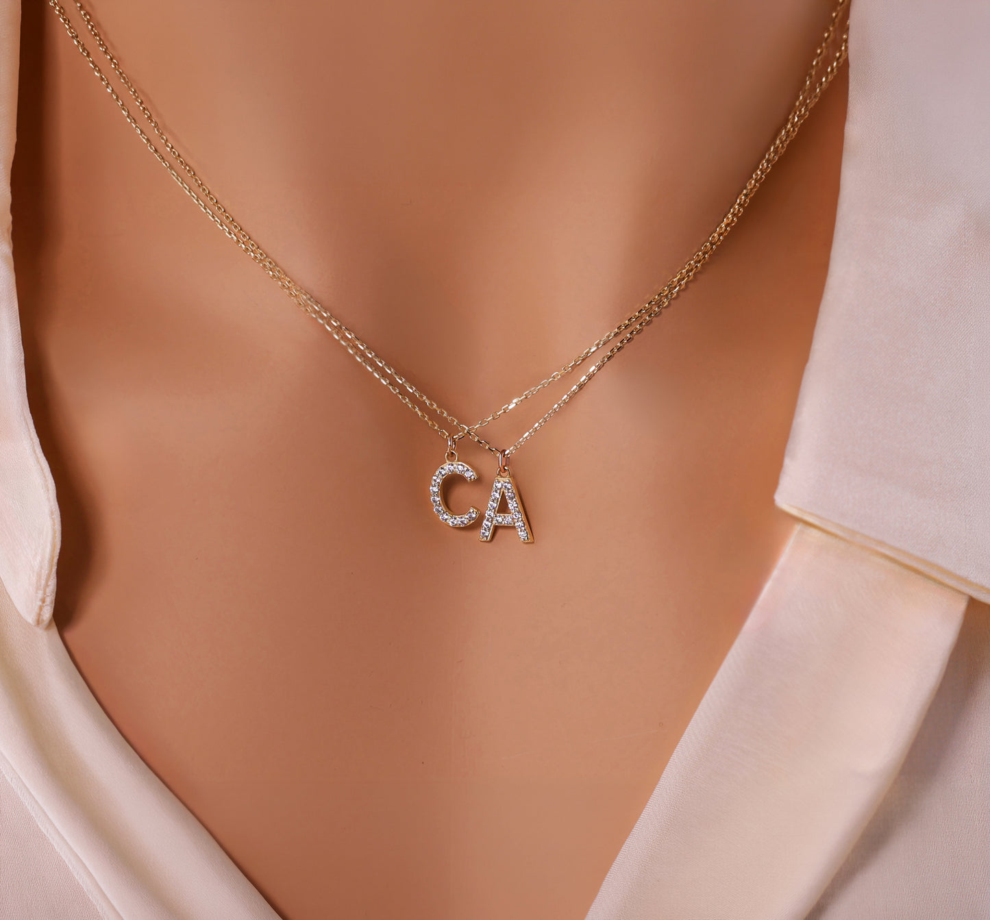 solid gold diamond paved letter c and a initial pendants worn layered as a trendy fashion statement.