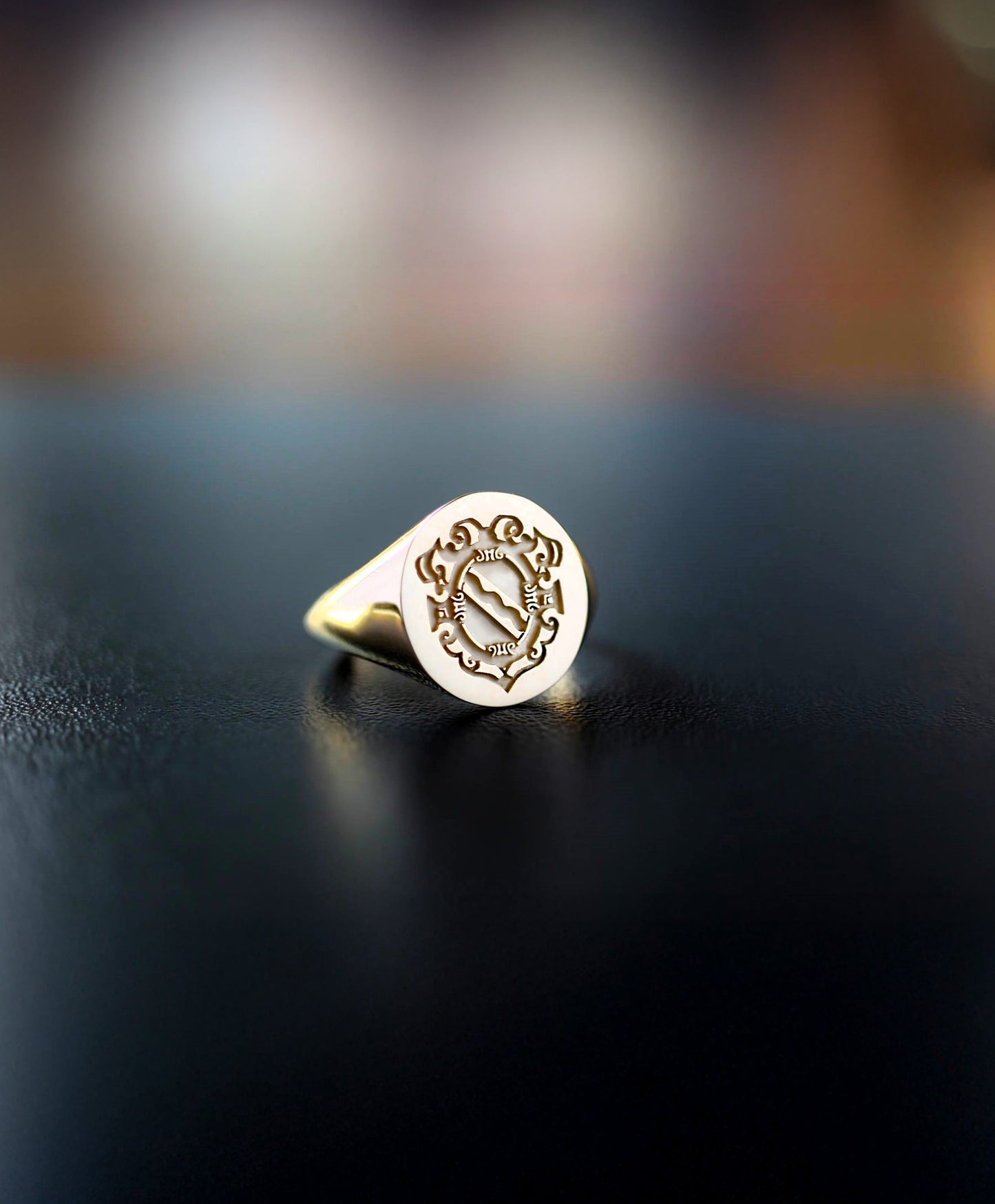 Gold signet ring engraved with a family crest design 