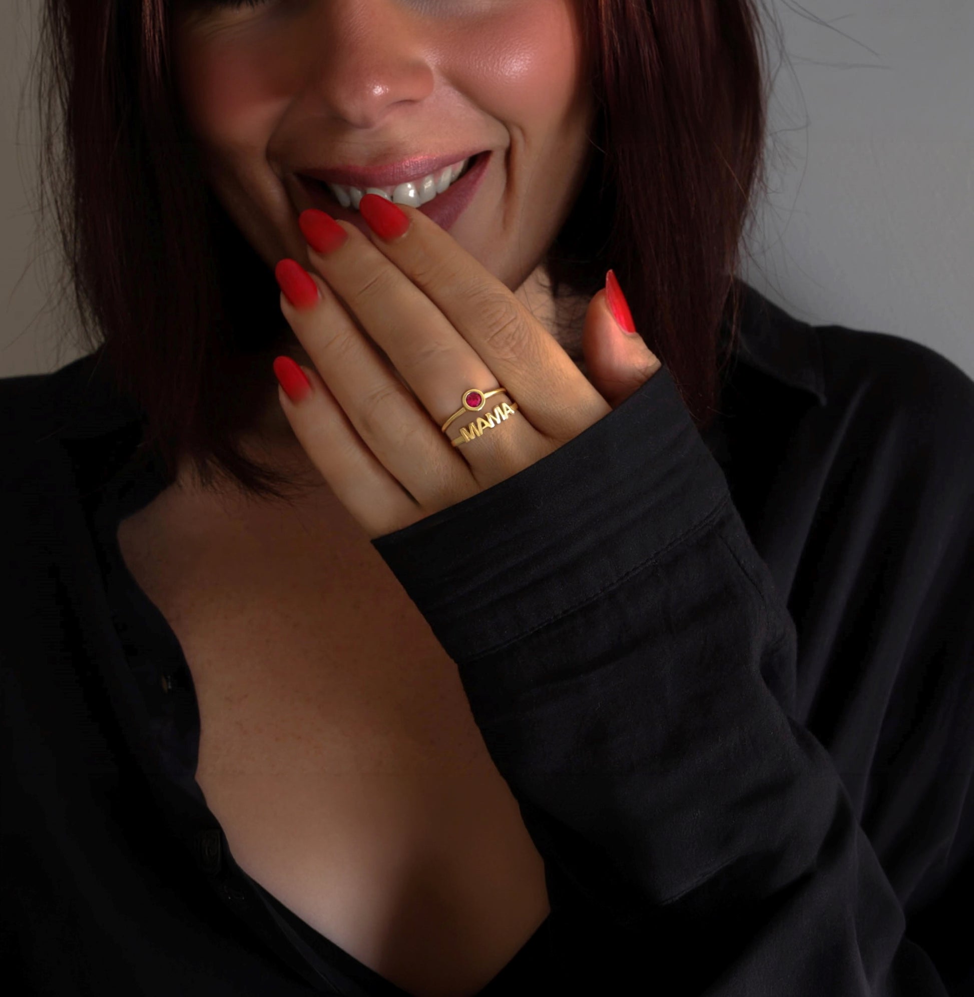 Woman wearing a gold MAMA ring.