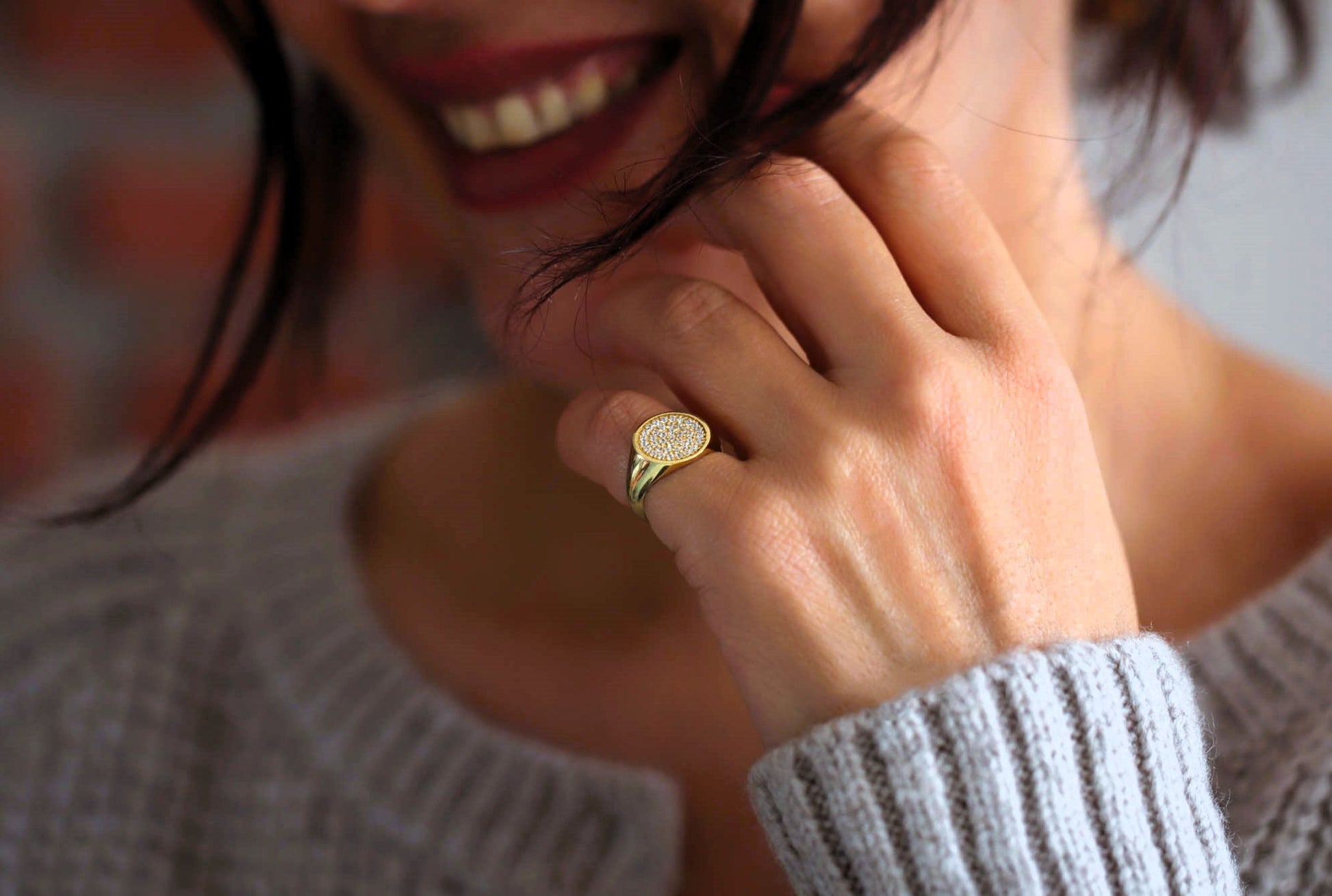 Close up of a 14k gold ladies pinky ring with diamonds.
