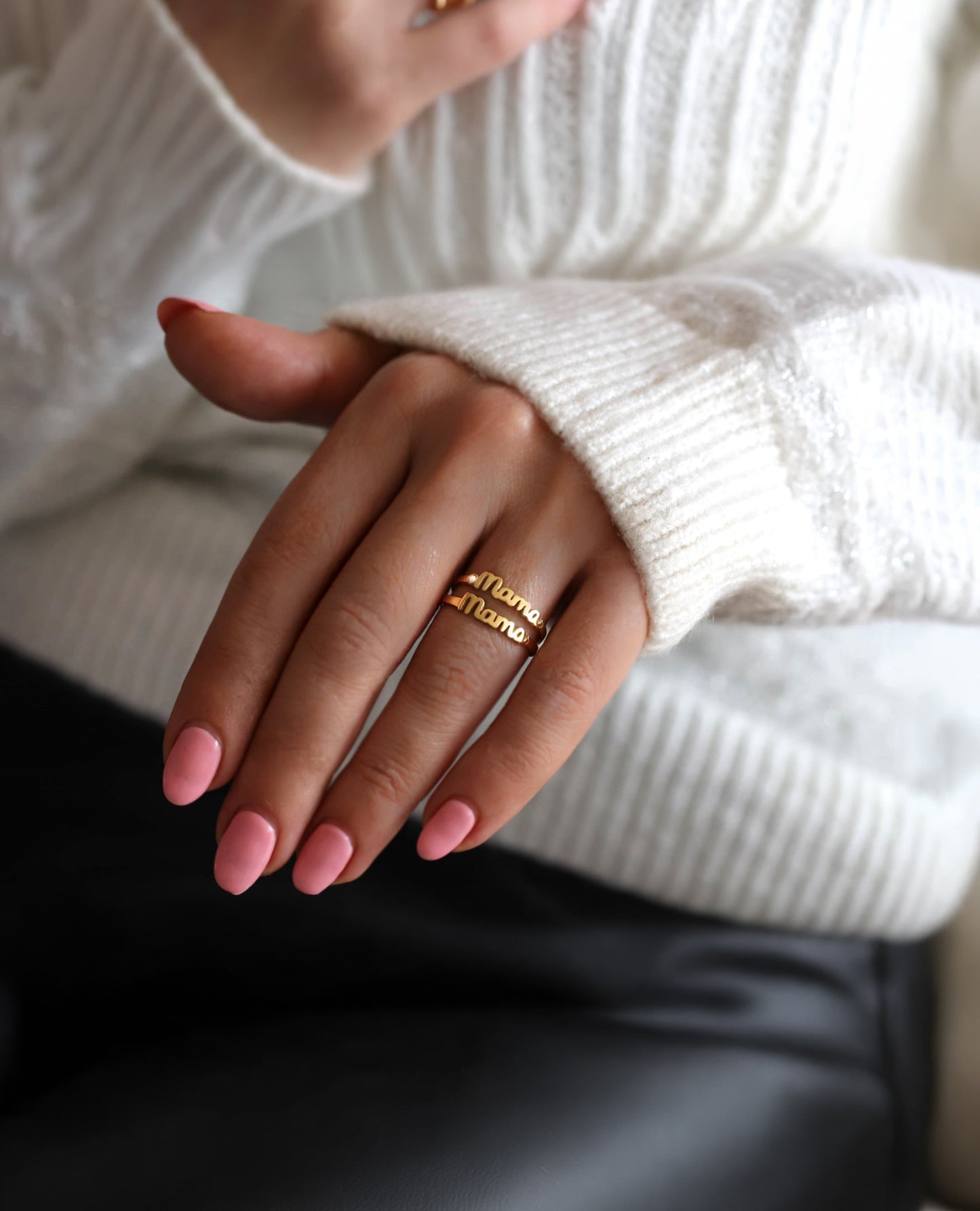 Trendy modern mother wearing gold mama rings as mother's day gift.