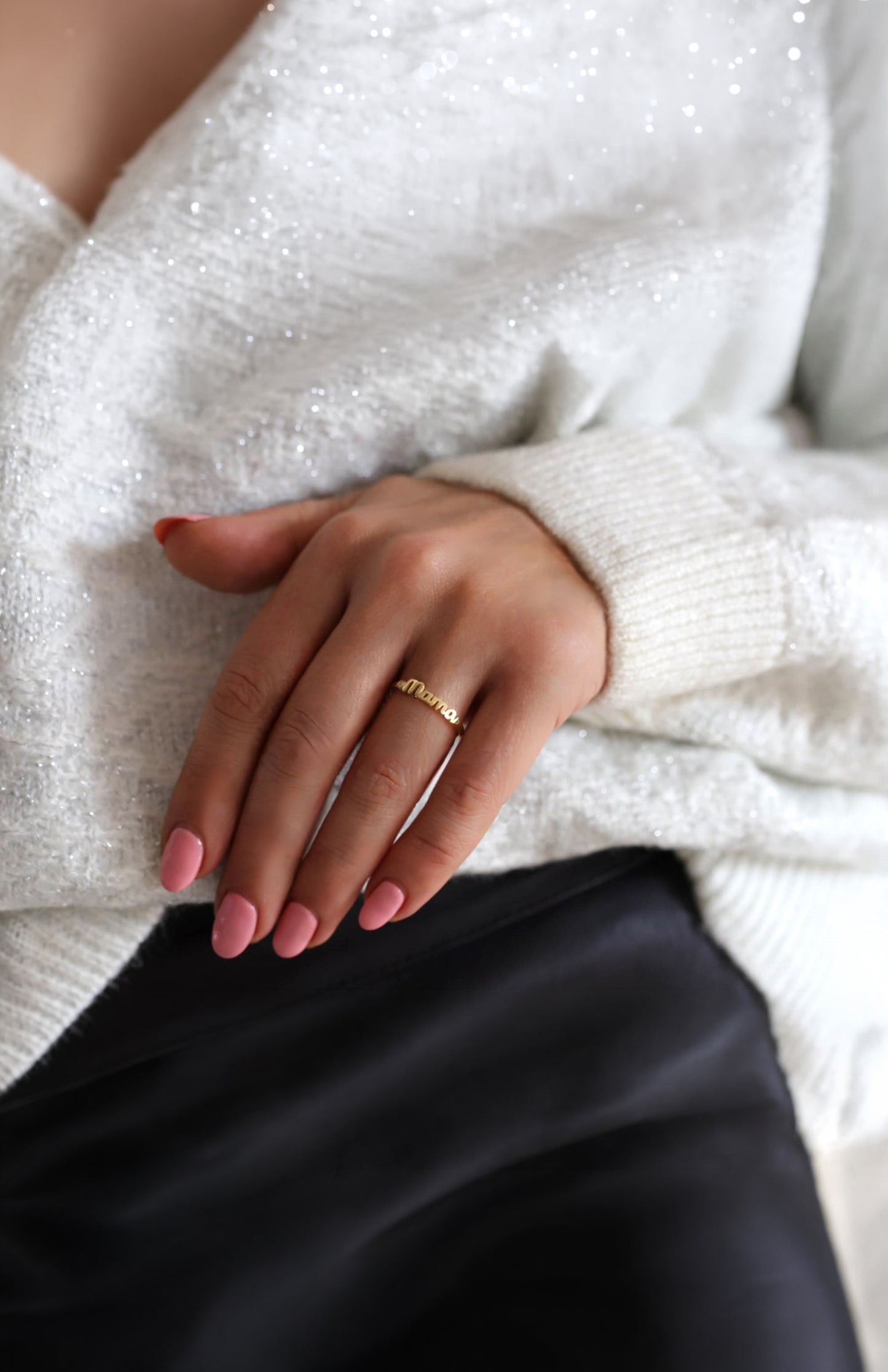 Gold mama ring on a mother's hand.