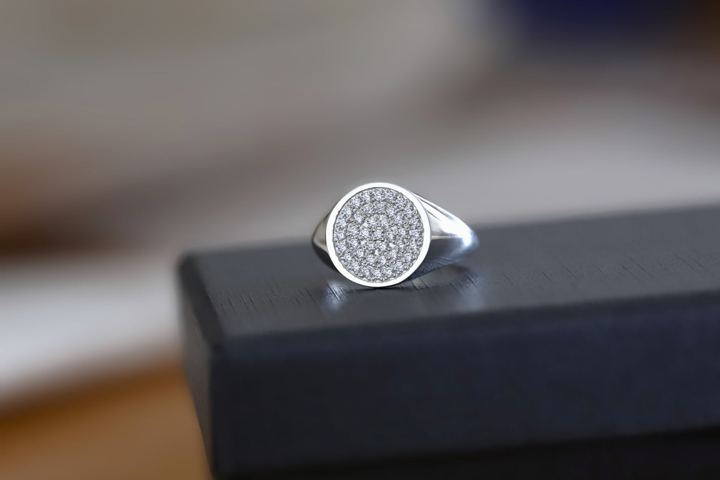 silver signet ring with a fully cz diamond paved face.